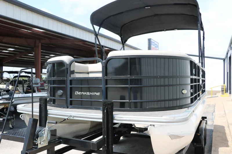 Slide: The Image of 2019 Berkshire 20RFC CTS pontoon boat on trailer in storage facility. - 7