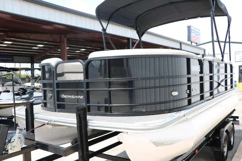 Slide: The Image of 2019 Berkshire 20RFC CTS pontoon boat with black exterior and canopy on trailer. - 8