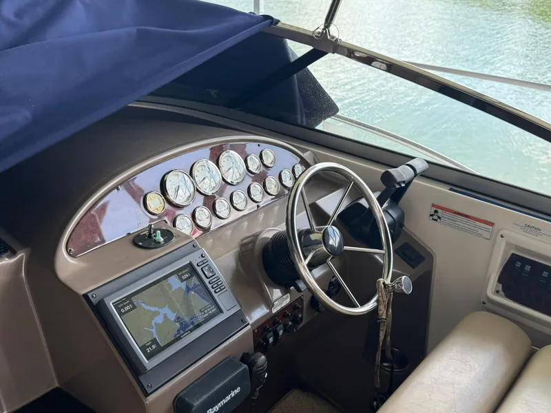 Slide: The Image of 2006 Regal 3360 Window Express boat dashboard with steering wheel and navigation system. - 12