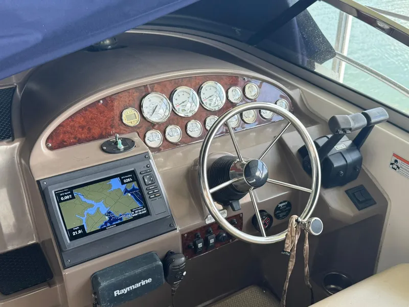Slide: The Image of 2006 Regal 3360 Window Express helm with navigation system and gauges. - 13