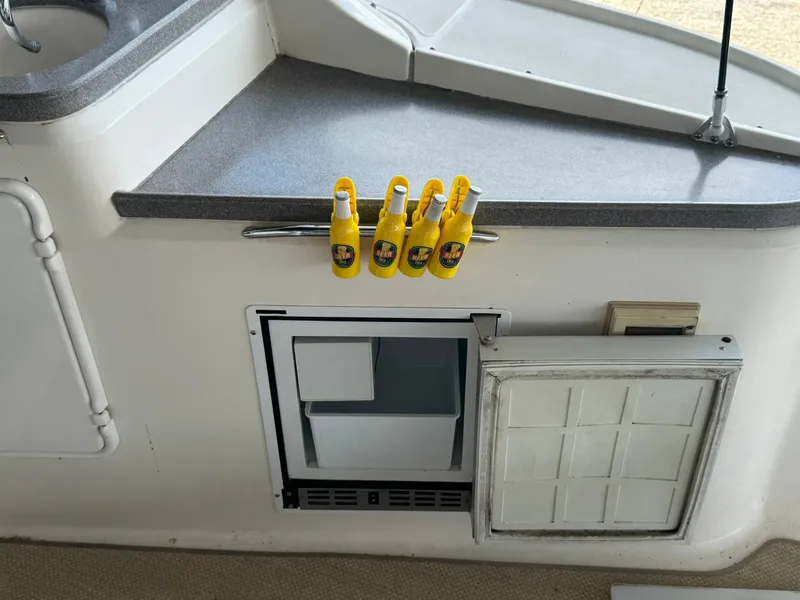 Slide: The Image of 2006 Regal 3360 Window Express boat interior with countertop and mini fridge. - 15