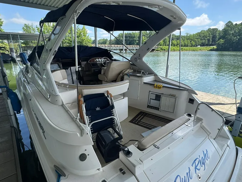 Slide: The Image of 2006 Regal 3360 Window Express boat docked by a scenic lake. - 19