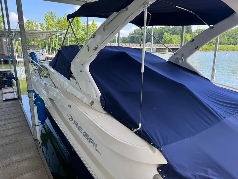 Slide: The Image of 2006 Regal 3360 Window Express boat docked with blue cover. - 2