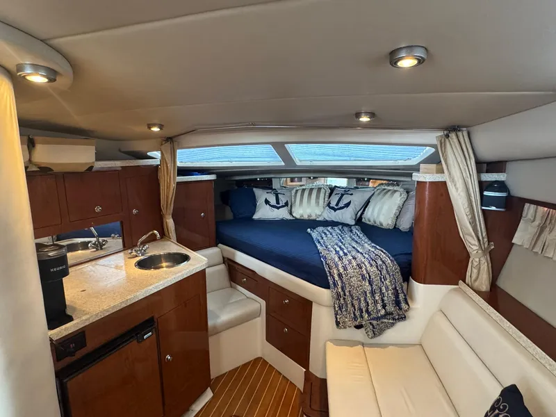 Slide: The Image of 2006 Regal 3360 Window Express cabin interior with kitchenette and cozy sleeping area. - 22
