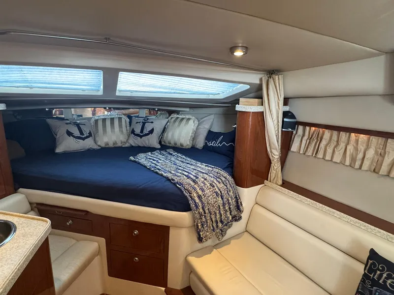Slide: The Image of Interior of 2006 Regal 3360 Window Express yacht with cozy bed and nautical decor. - 23