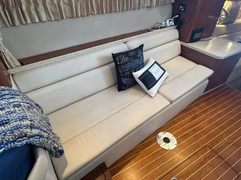 Slide: The Image of Interior of 2006 Regal 3360 Window Express with beige seating and decorative pillows. - 28