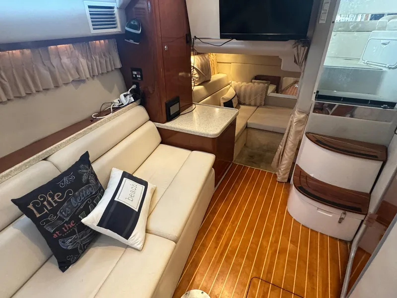 Slide: The Image of Interior of 2006 Regal 3360 Window Express yacht with cozy seating and wooden flooring. - 29