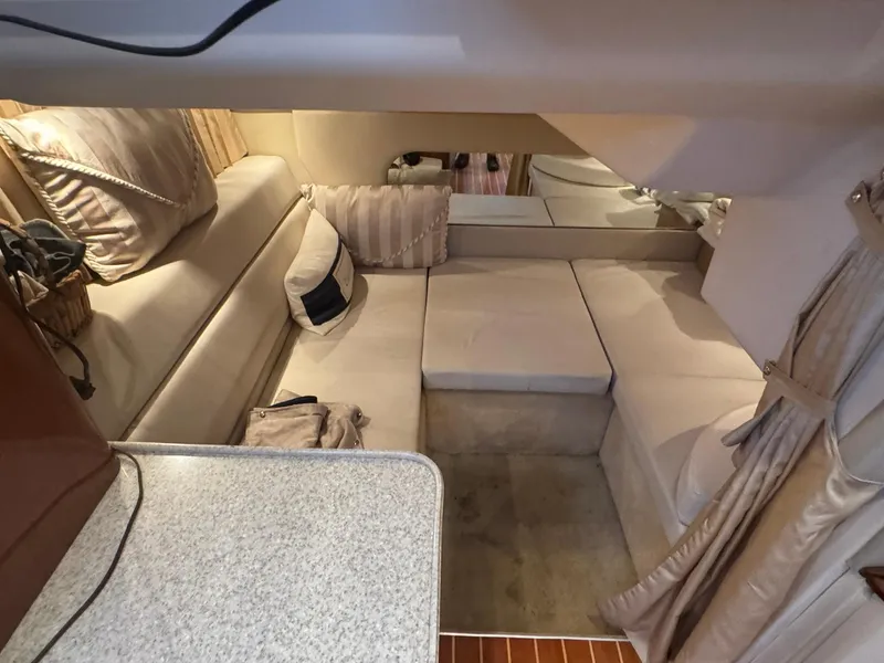 Slide: The Image of Interior of 2006 Regal 3360 Window Express yacht with beige seating and cushions. - 32