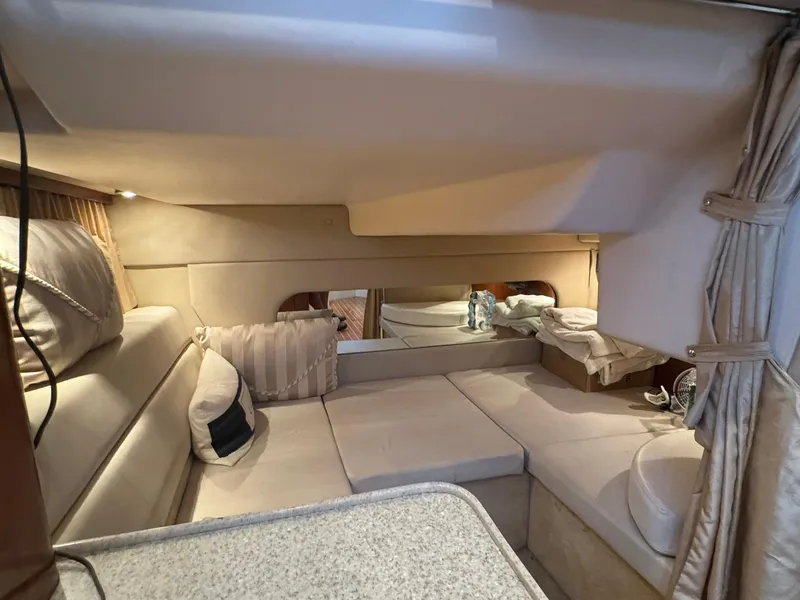 Slide: The Image of 2006 Regal 3360 Window Express cabin interior with beige seating and cushions. - 33