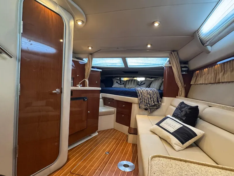 Slide: The Image of Interior of 2006 Regal 3360 Window Express yacht with cozy seating and elegant wood finishes. - 34