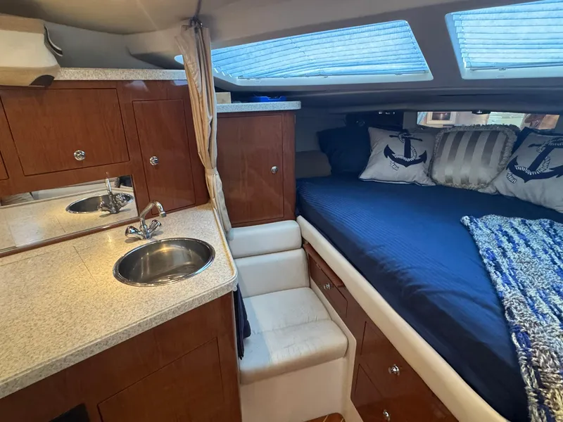 Slide: The Image of 2006 Regal 3360 Window Express cabin with bed, sink, and wooden cabinetry. - 35