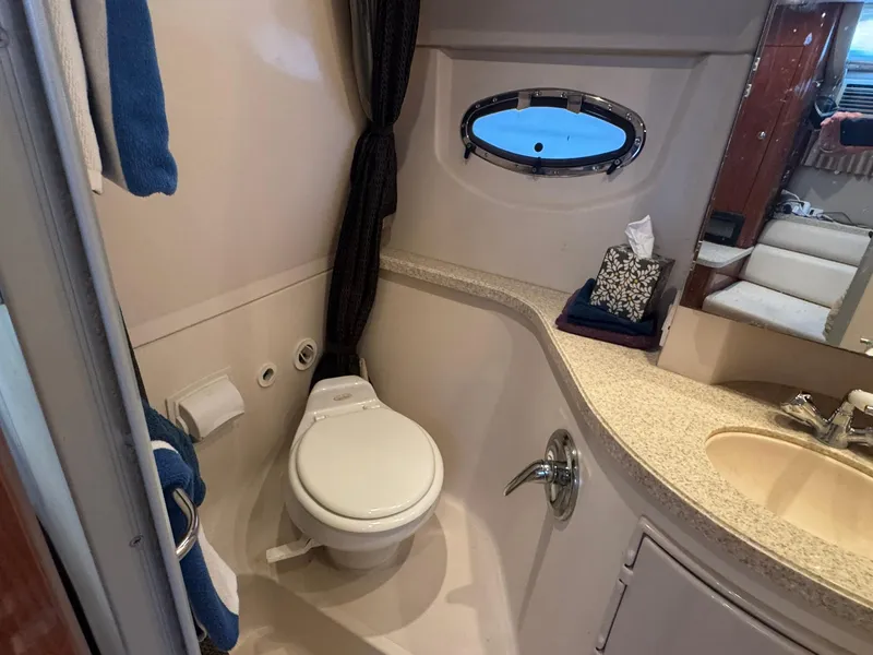 Slide: The Image of Bathroom interior of 2006 Regal 3360 Window Express yacht, featuring toilet and sink. - 36