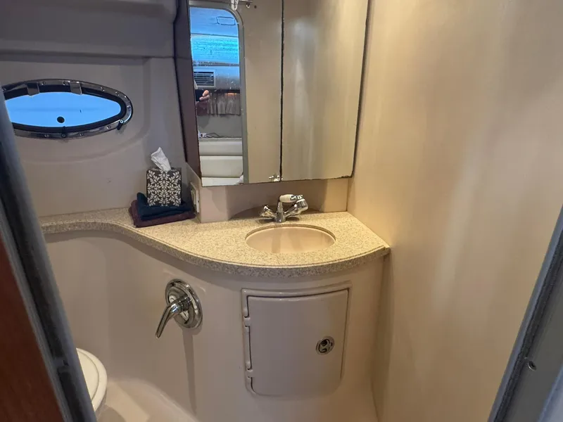 Slide: The Image of Bathroom interior of 2006 Regal 3360 Window Express yacht, featuring sink and mirror. - 37