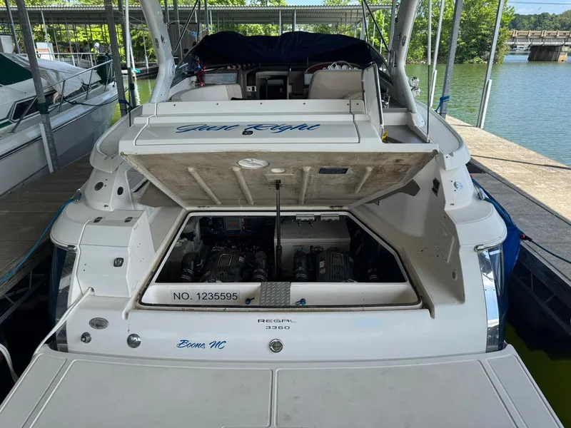 Slide: The Image of 2006 Regal 3360 Window Express boat with open engine compartment at dock. - 38