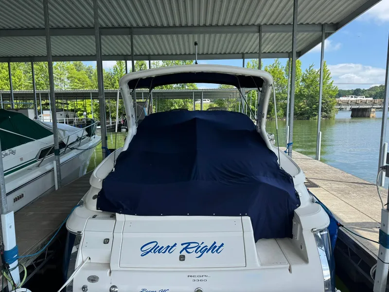 Slide: The Image of 2006 Regal 3360 Window Express boat docked under a covered marina. - 6