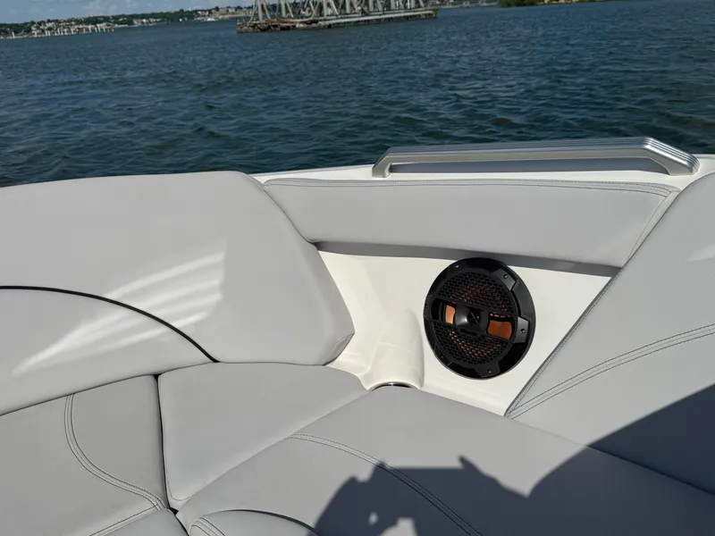 Slide: The Image of 2019 MasterCraft XT22 boat interior with speaker, on a calm lake. - 14