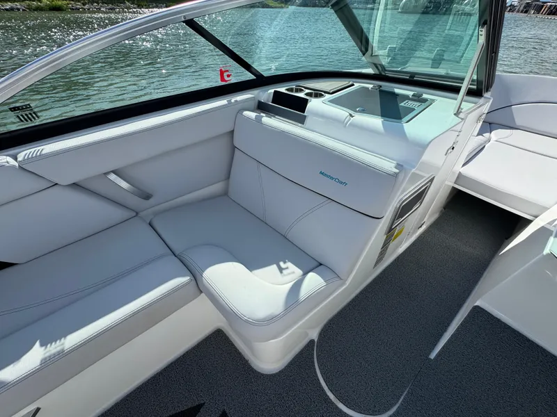 Slide: The Image of 2019 MasterCraft XT22 boat interior with white seating and sleek design. - 18