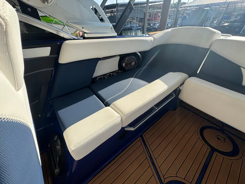 Slide: The Image of Interior of 2021 MasterCraft XT23 boat with blue and white seating. - 18