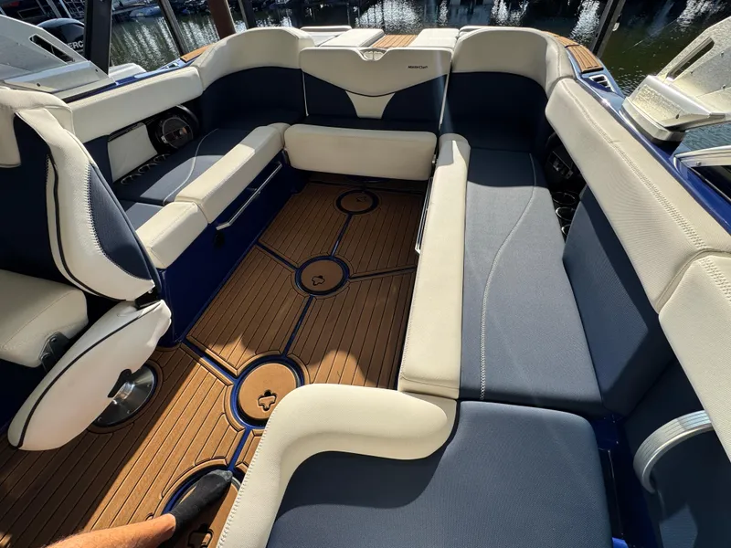 Slide: The Image of 2021 MasterCraft XT23 boat interior with luxurious seating and stylish flooring. - 19