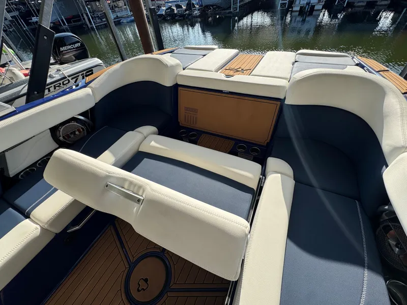Slide: The Image of Interior of a 2021 MasterCraft XT23 boat with luxurious seating and cup holders. - 20
