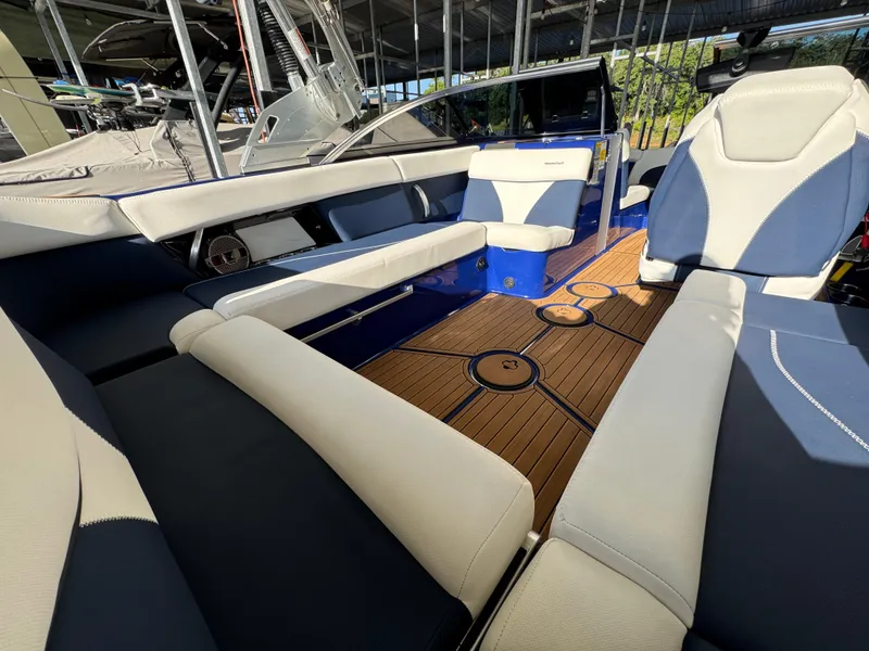 Slide: The Image of 2021 MasterCraft XT23 boat interior with luxurious seating and stylish wooden flooring. - 21