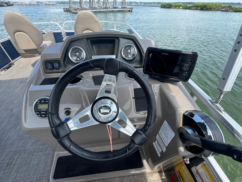 Slide: The Image of 2021 Ranger Reata 200F boat dashboard with steering wheel and navigation system. - 14