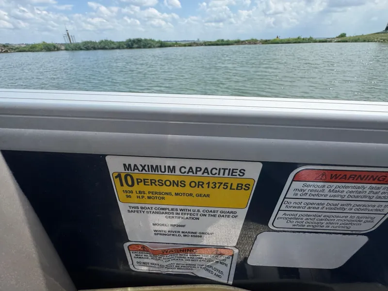 Slide: The Image of 2021 Ranger Reata 200F boat capacity label, maximum 10 persons or 1375 lbs. - 15