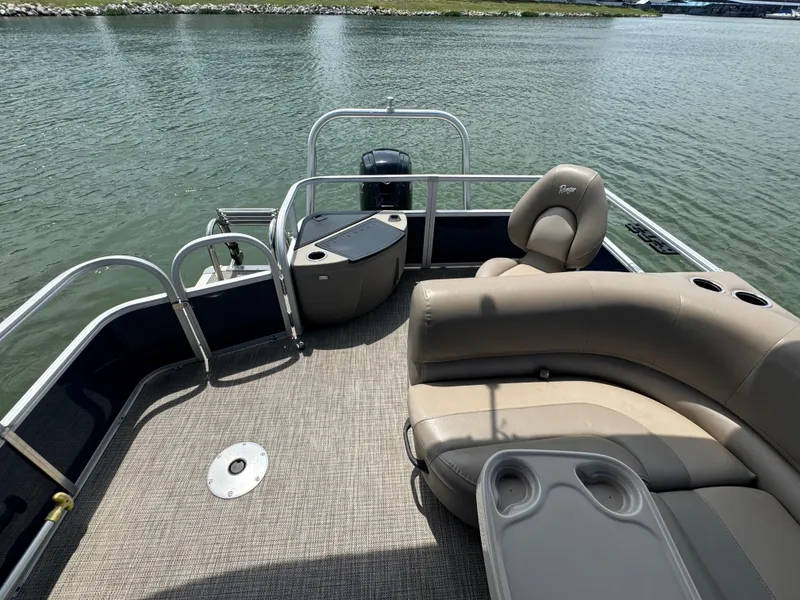 Slide: The Image of 2021 Ranger Reata 200F pontoon boat interior with seating and water view. - 16