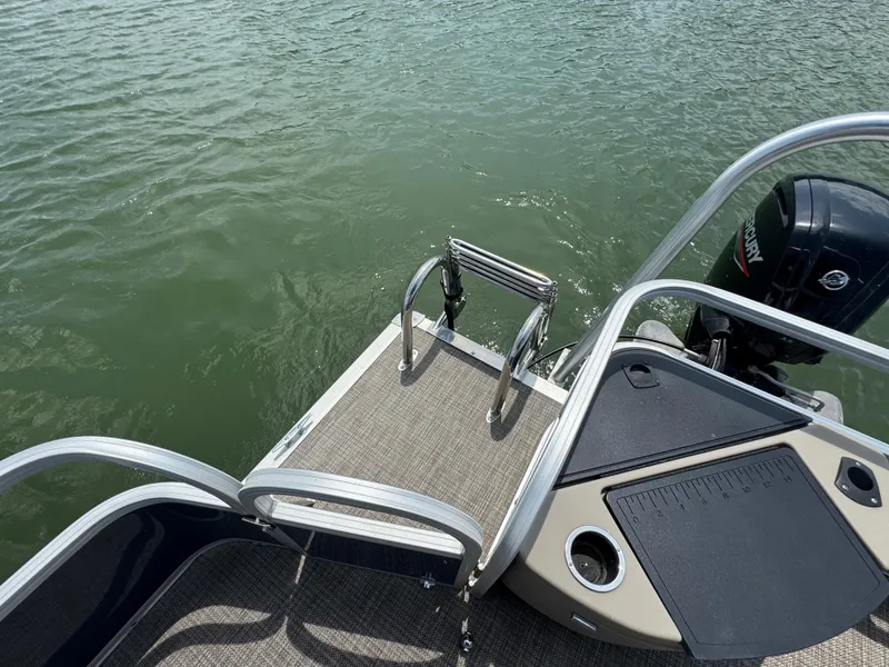 Slide: The Image of 2021 Ranger Reata 200F boat with Mercury engine and swim ladder on calm water. - 18