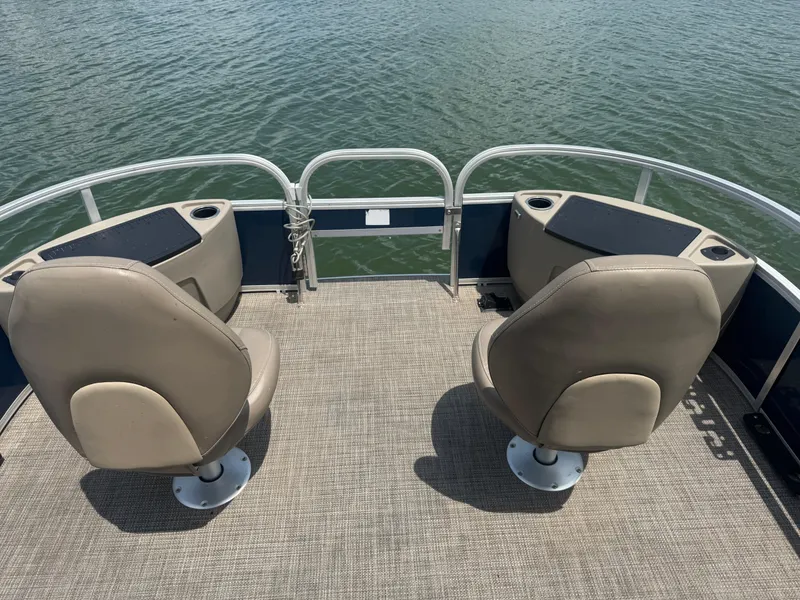 Slide: The Image of 2021 Ranger Reata 200F boat with two seats on deck, overlooking water. - 7