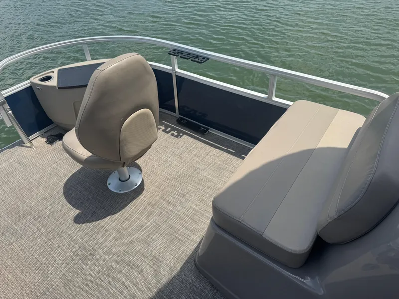 Slide: The Image of 2021 Ranger Reata 200F boat interior with seating, on calm water. - 8