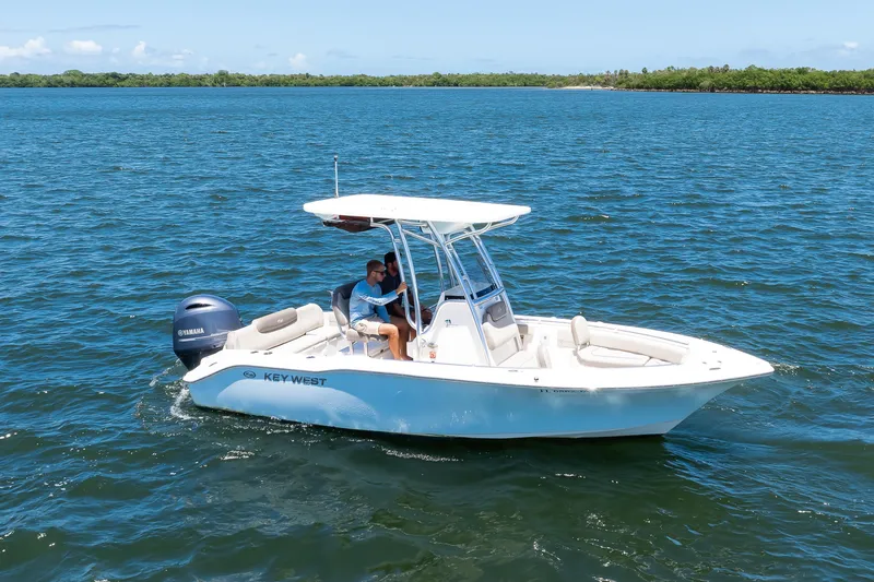 Slide: The Image of 2021 Key West 219 FS boat cruising on open water under clear skies. - 13