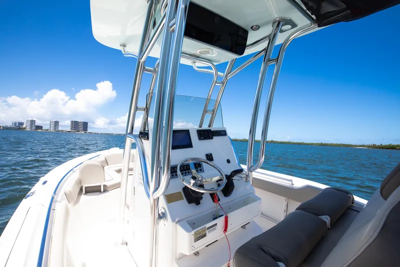 Slide: The Image of 2021 Key West 219 FS boat on water, featuring sleek console and clear blue sky. - 4