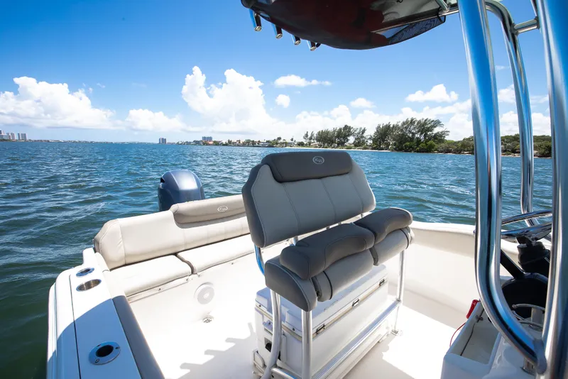Slide: The Image of 2021 Key West 219 FS boat interior with seating, on a sunny day at sea. - 6