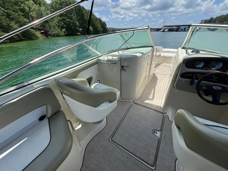Slide: The Image of 2006 Sea Ray 270 Sundeck interior with seating, dashboard, and lake view. - 25
