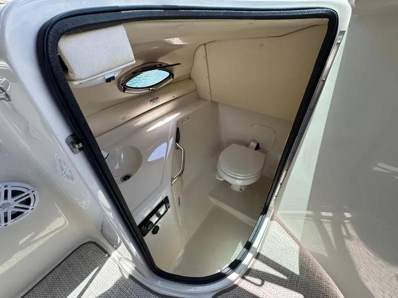 Slide: The Image of 2006 Sea Ray 270 Sundeck boat interior with compact bathroom and toilet. - 26