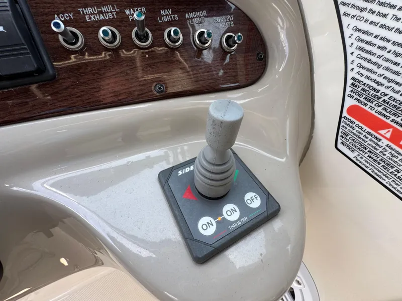 Slide: The Image of Control panel of a 2006 Sea Ray 270 Sundeck with switches and thruster joystick. - 31