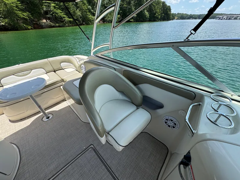Slide: The Image of 2006 Sea Ray 270 Sundeck interior with seating, table, and lake view. - 33