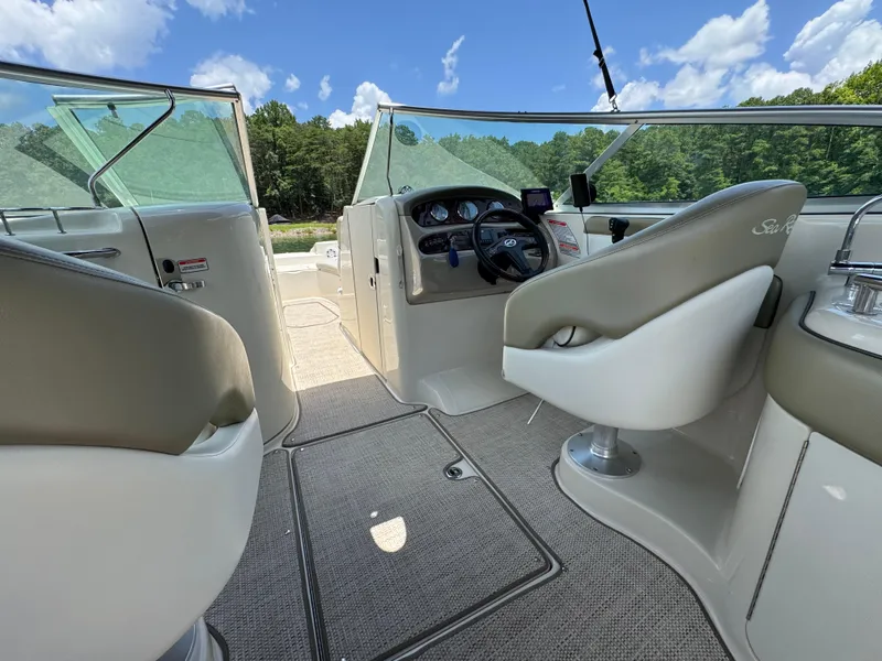 Slide: The Image of Interior view of 2006 Sea Ray 270 Sundeck boat with steering wheel and seating. - 34