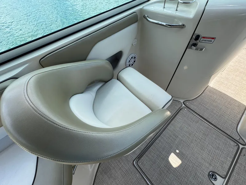 Slide: The Image of Captain's seat on 2006 Sea Ray 270 Sundeck boat, near water. - 35