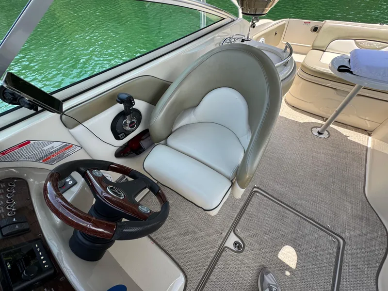 Slide: The Image of Interior of a 2006 Sea Ray 270 Sundeck boat with steering wheel and seating. - 36