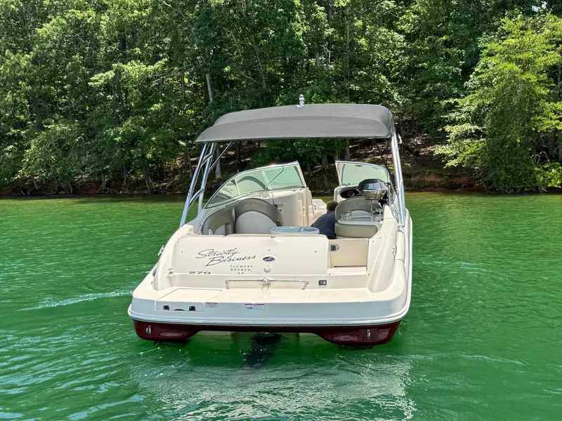 Slide: The Image of 2006 Sea Ray 270 Sundeck boat on green water, surrounded by lush trees. - 6