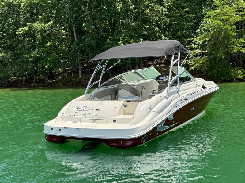 Slide: The Image of 2006 Sea Ray 270 Sundeck boat on green water, surrounded by lush trees. - 7