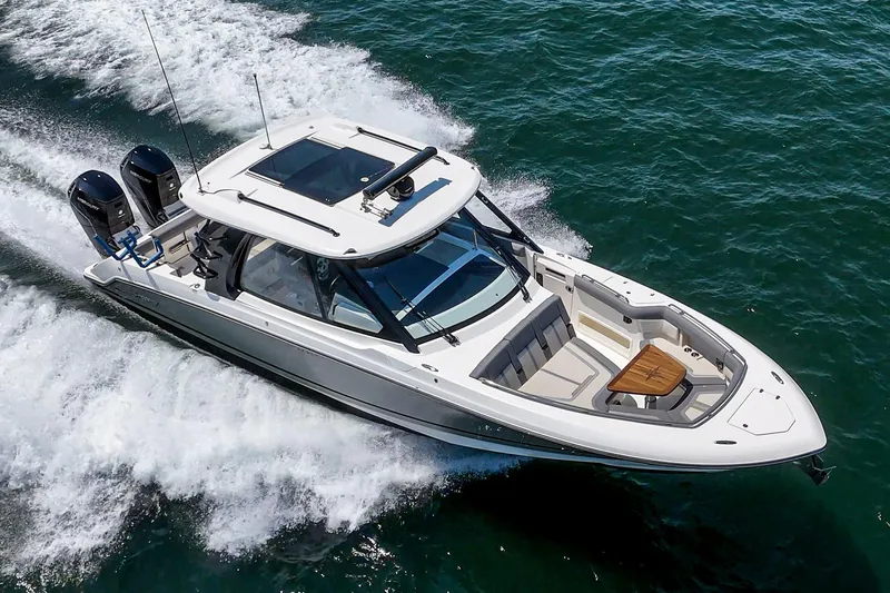 Slide: The Image of 2024 Boston Whaler 380 Realm cruising on open water, showcasing sleek design and powerful engines. - 18