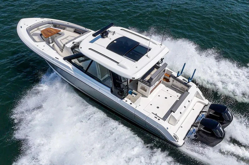 Slide: The Image of 2024 Boston Whaler 380 Realm cruising on open water, showcasing sleek design and powerful engines. - 21