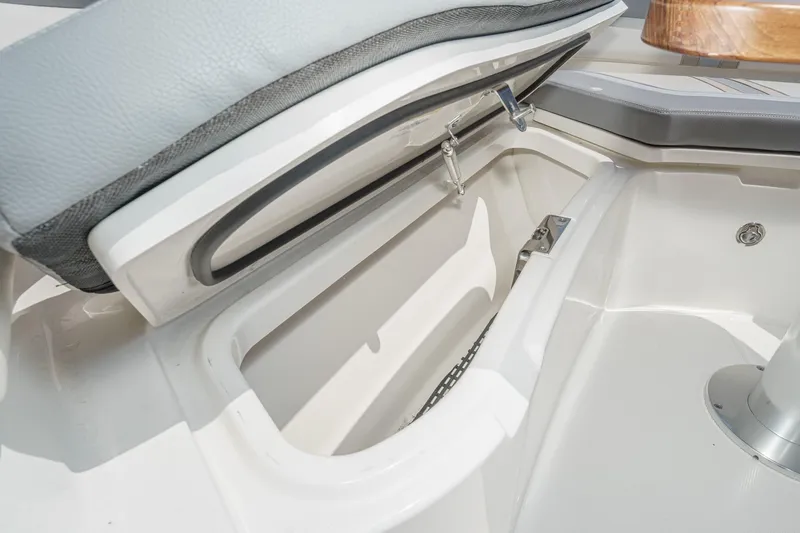 Slide: The Image of 2024 Boston Whaler 380 Realm storage compartment with cushioned seating and sleek design. - 34