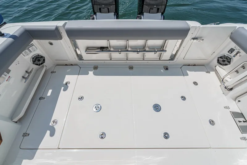 Slide: The Image of 2024 Boston Whaler 380 Realm boat deck with seating and storage compartments. - 42