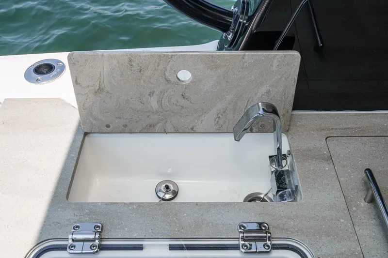 Slide: The Image of 2024 Boston Whaler 380 Realm boat sink with modern faucet and countertop. - 56