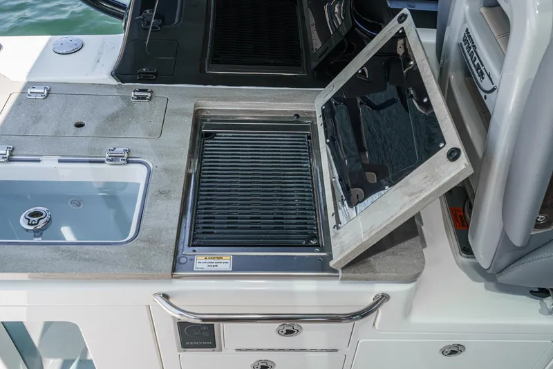Slide: The Image of 2024 Boston Whaler 380 Realm boat grill and sink setup on deck. - 57