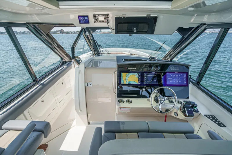 Slide: The Image of 2024 Boston Whaler 380 Realm helm with advanced navigation displays and luxurious seating. - 59